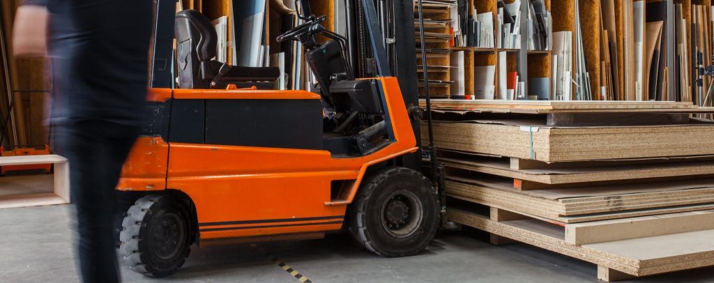 Forklift in a warehouse moving a pallet